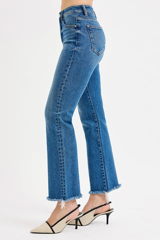 Blue jeans worn by a person on a white background