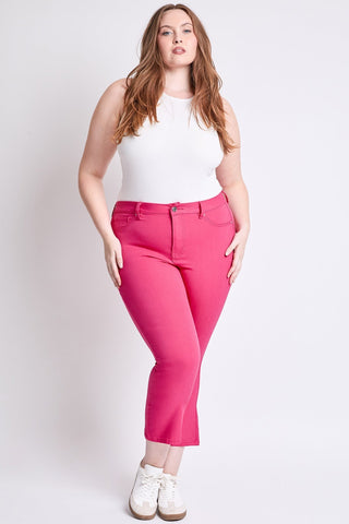 Woman wearing a white top and pink pants on a white background