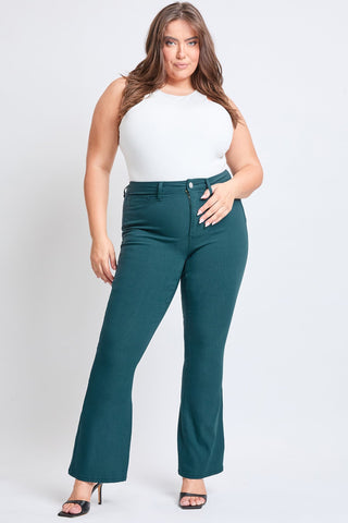 Woman wearing teal pants and a white top on a white background
