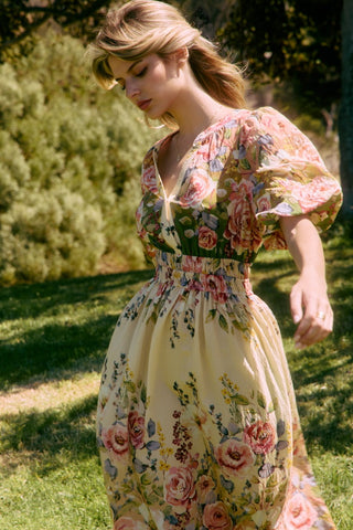 Woman wearing a floral dress in an outdoor setting