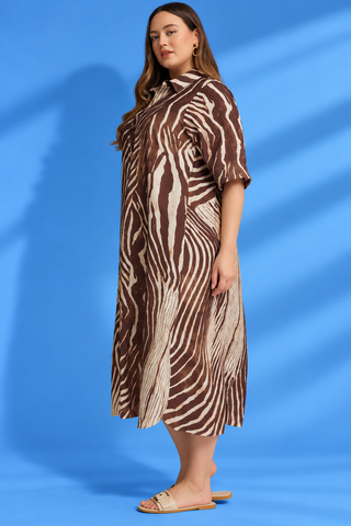 Midi Dress featuring a zebra-inspired print, collared neckline, half-button front, and flattering midi silhouette.