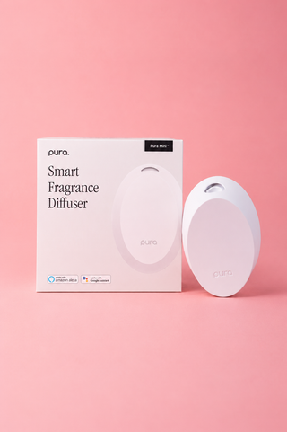 Pura smart fragrance diffuser packaging and diffuser on a pink background