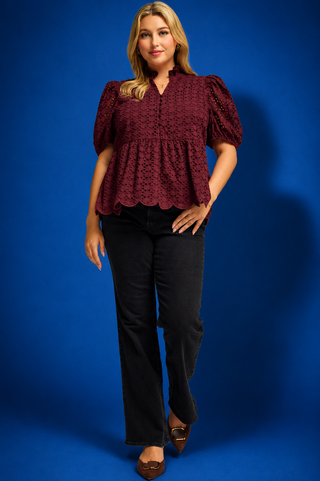  a burgundy eyelet lace short-sleeve blouse with puff sleeves and a scalloped hem