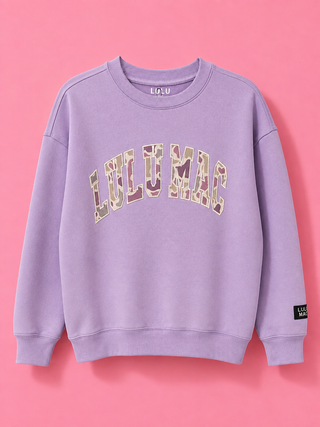 Camo Lilac Crewneck Sweatshirt with a camo appliqué, fleece-lined interior, relaxed fit, and soft cotton-blend comfort.