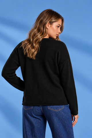 Black long sleeve top with a relaxed fit, round neckline, dropped shoulders, and center seam detail.