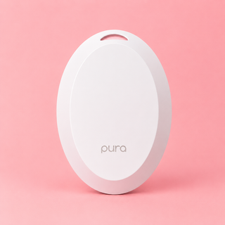 White circular device with 'pura' branding on a pink background