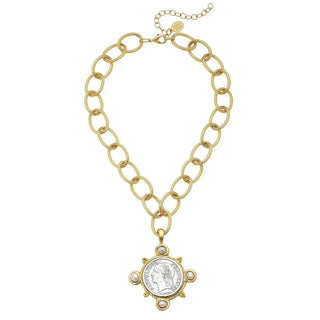 Gold chain necklace with a pendant on a white background