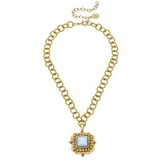 Gold chain necklace with a square pendant on a white background