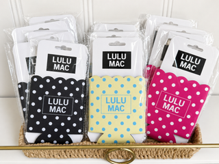 Packaged Lulu Mac products with polka dot designs on a white background