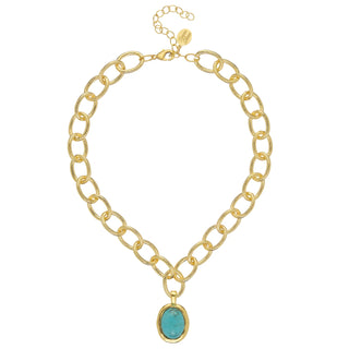 Gold chain necklace with a turquoise pendant on a white background