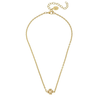 Gold necklace with a small floral pendant on a white background