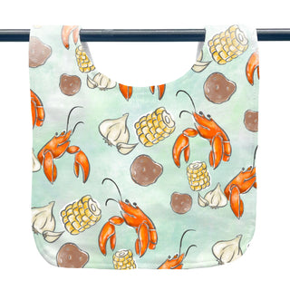 Bib with lobster, corn, and garlic pattern on a light blue background