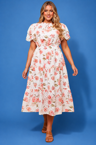 Woman wearing a floral dress against a blue background