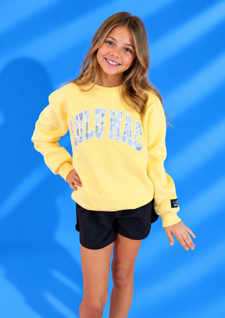 Butter Yellow & White Camo Patch Sweatshirt with cozy fleece lining and oversized camo patch lettering.