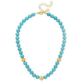 Turquoise beaded necklace with gold accents on a white background