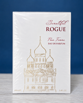 Perfume bottle and packaging of 'Beautiful Rogue' on a blue background