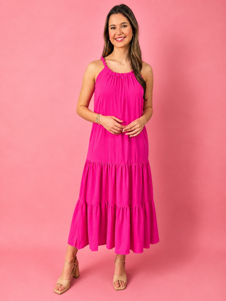 Woman wearing a pink dress against a pink background