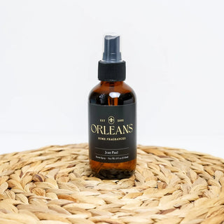 Orleans home fragrances bottle on a woven surface