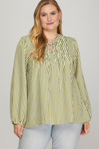 Woman wearing a green and white striped blouse against a plain background