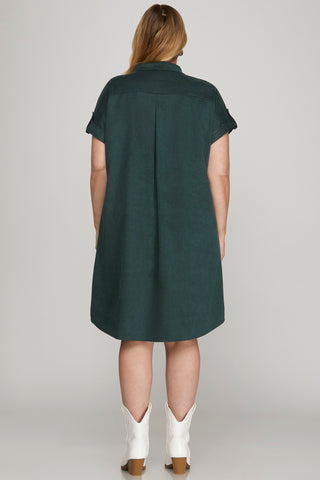 Green dress worn by a person on a plain background