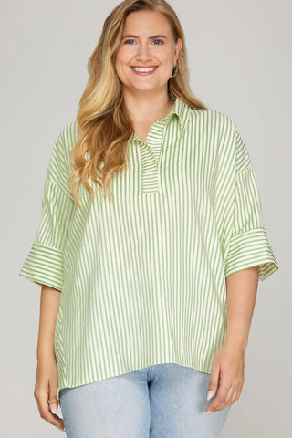 Woman wearing a green and white striped shirt against a plain background