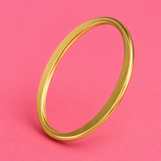 Gold bracelet on a pink background