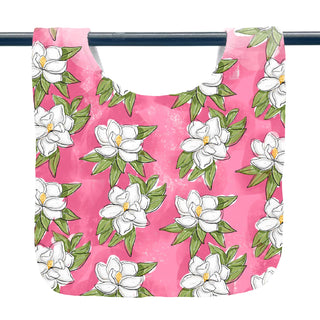 bib with Pink fabric with white floral pattern on a white background