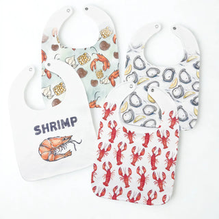 Set of three baby bibs with seafood-themed designs on a white background