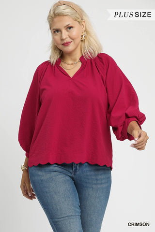 Woman wearing a red blouse and blue jeans on a white background
