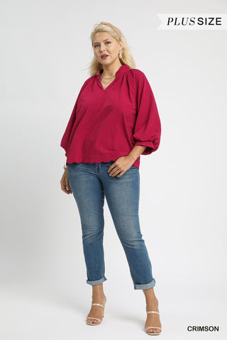 Woman wearing a red blouse and blue jeans on a white background