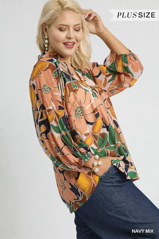 Woman wearing a plus-size floral blouse with a plain background