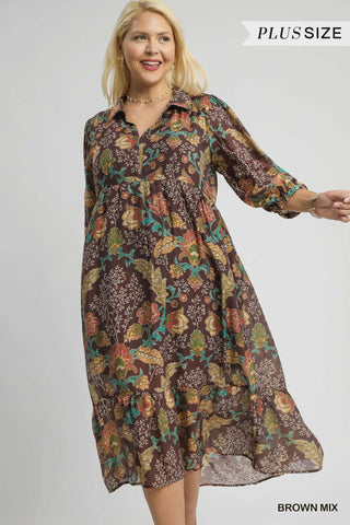 Woman wearing a floral patterned dress on a plain background