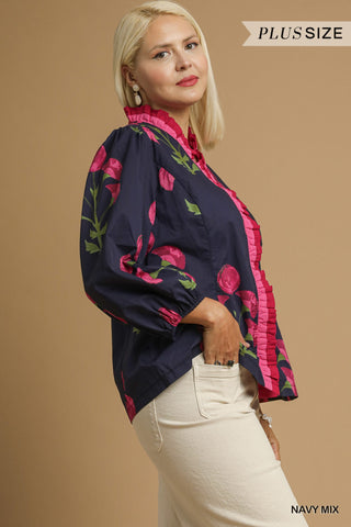 Woman wearing a navy blouse with pink floral patterns on a beige background