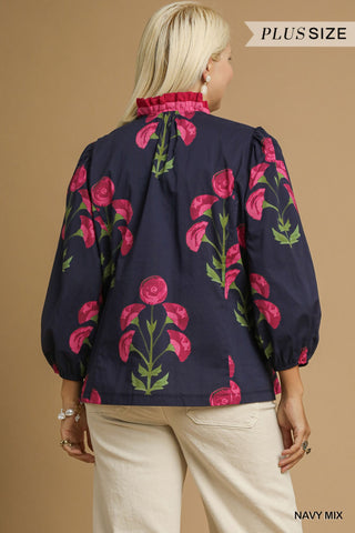 Woman wearing a navy blouse with pink floral patterns on a beige background