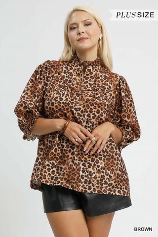 Woman wearing a leopard print blouse with text indicating 'Plus Size' and 'Brown'.