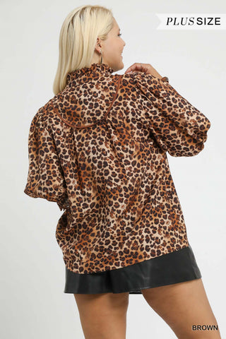 Woman wearing a leopard print blouse and black skirt on a white background