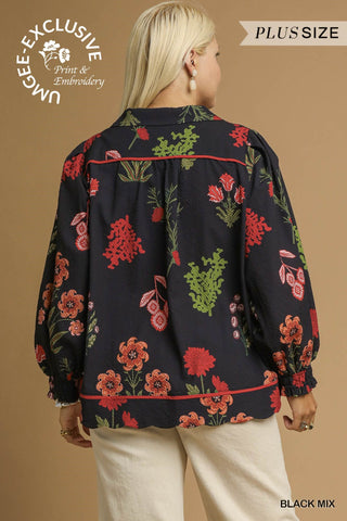 Woman wearing a black floral blouse with a beige background