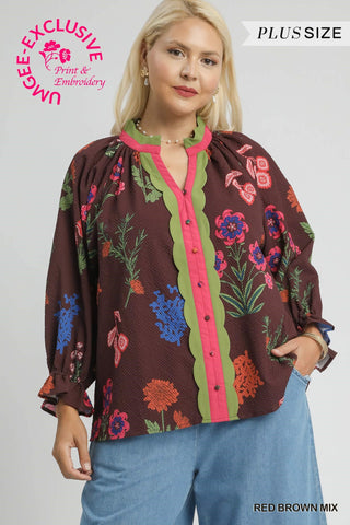 Woman wearing a plus-size floral blouse with a gray background