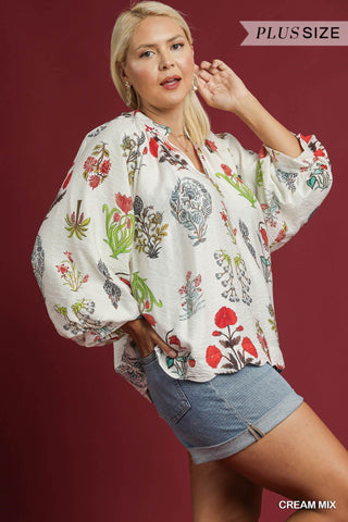 Woman wearing a floral blouse and denim shorts on a red background