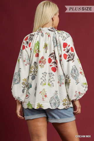 Woman wearing a plus-size floral blouse with a maroon background