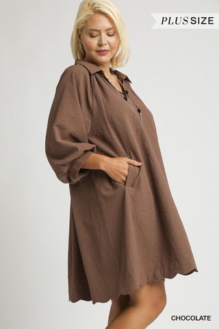 Woman wearing a brown plus-size dress on a white background