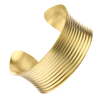 Gold bracelet with a ribbed design on a white background