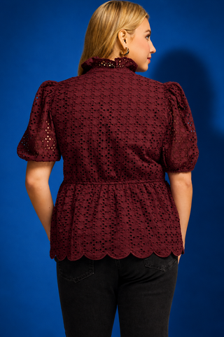  a burgundy eyelet lace short-sleeve blouse with puff sleeves and a scalloped hem