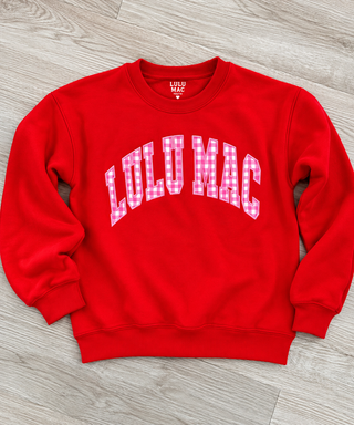 red crewneck sweatshirt with 'LULU MAC' in white arched letters