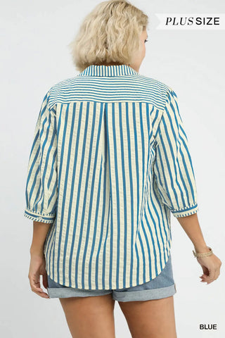 Woman wearing a blue and white striped shirt with text indicating 'Plus Size' and 'Blue'.