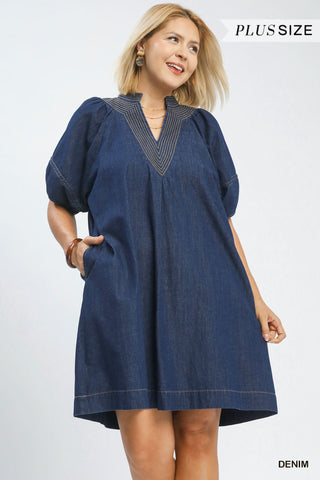 Woman wearing a denim dress with 'Plus Size' text on a white background