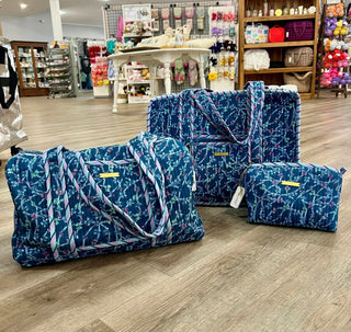 Set of blue patterned bags on a wooden floor in a store setting