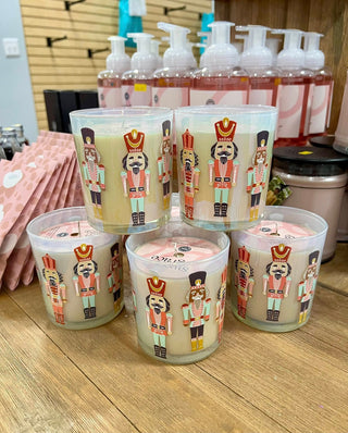 Candle holders with nutcracker design on a wooden surface