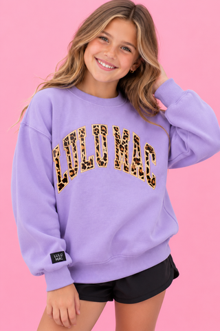 eaturing bold vertical leopard print applique lettering outlined in coordinating embroidery on a soft lavende