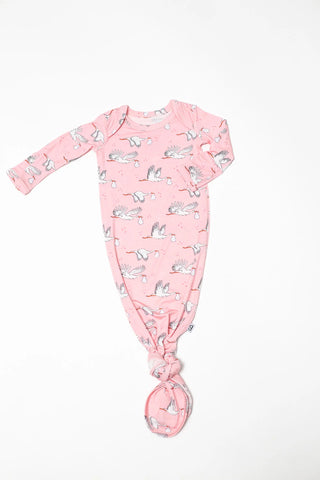 Pink baby onesie with animal pattern on a white background